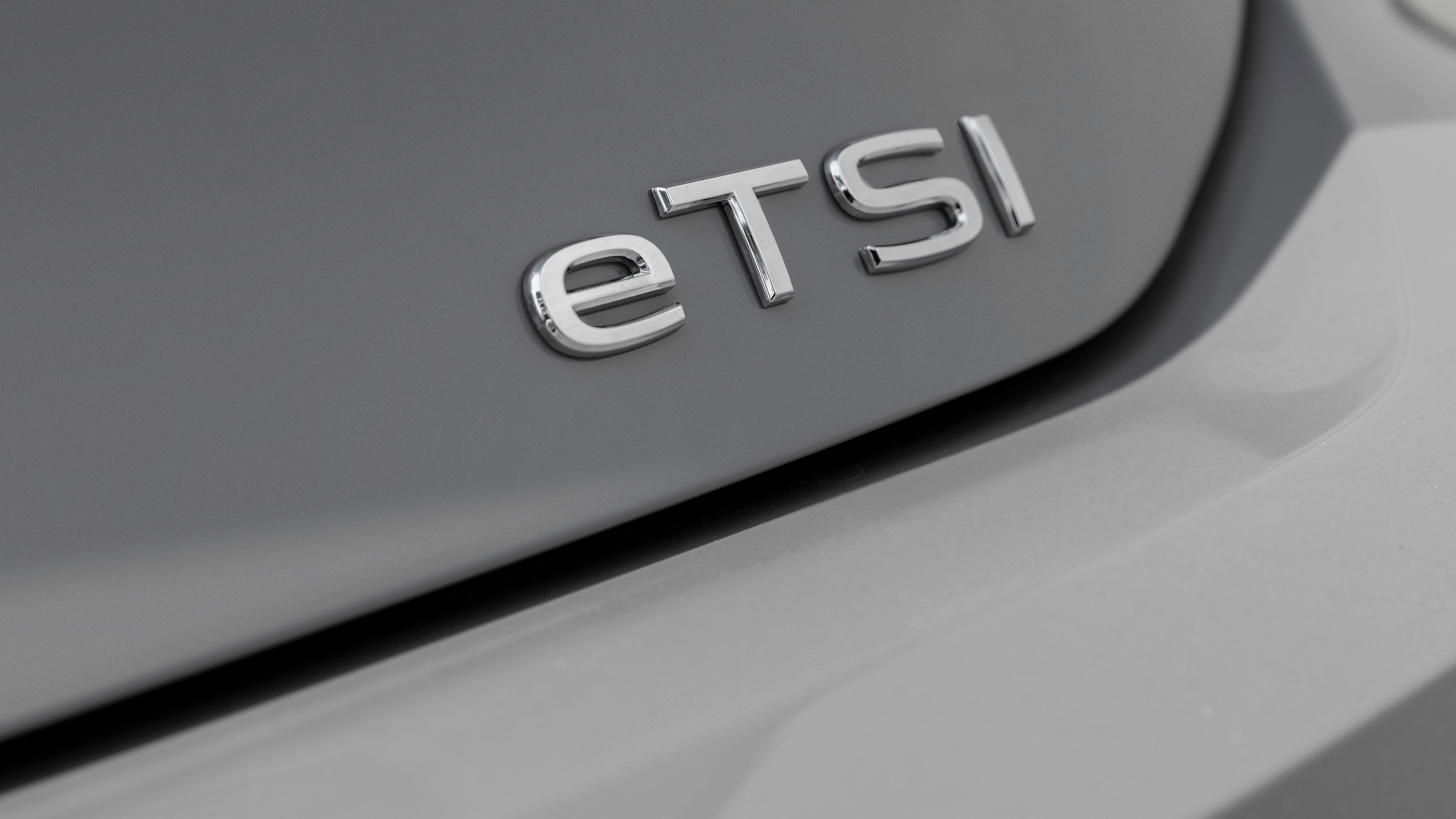 Volkswagen eTSI Engine Technology A close-up look of the exterior of a Volkswagen vehicle featuring the eTSI badge on the corner of its trunk.