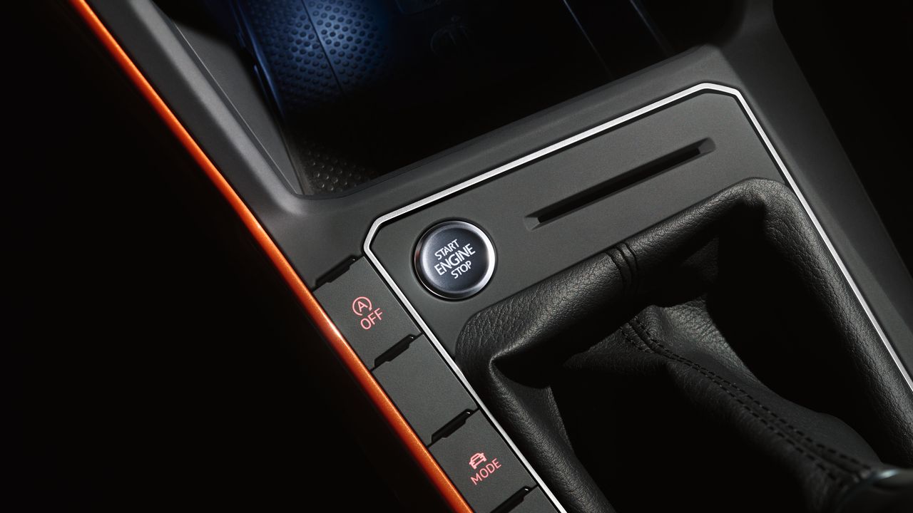 Volkswagen Stop-Start Technology | Where can I get it A close-up view of the Stop-Start button located in front of the gearbox of a Volkswagen vehicle.