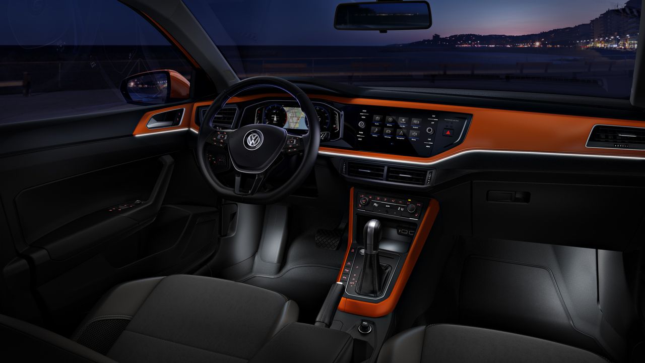 Lighting systems | Ambient lighting The look and feel of the interior of a Volkswagen vehicle with black and orange accents.