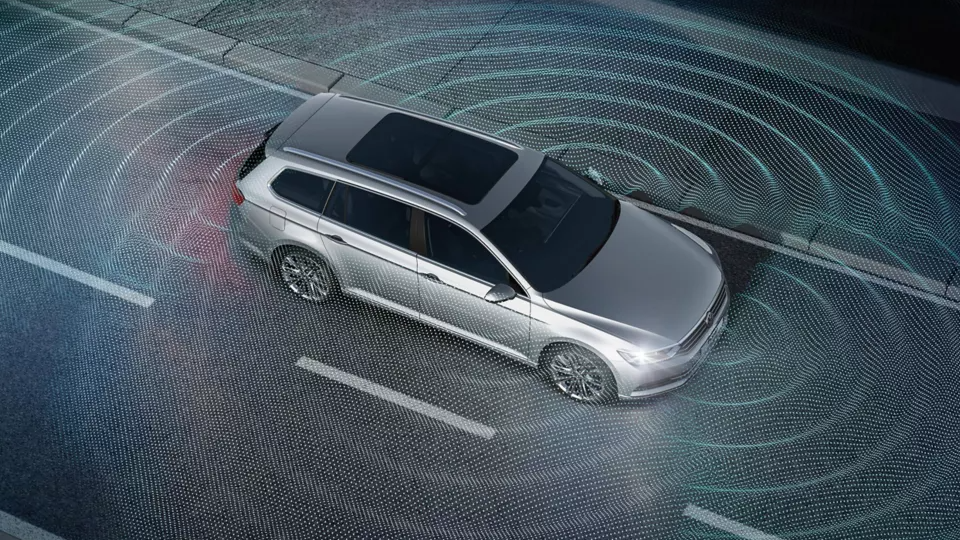 Parking sensors An image depicting a silver Volkswagen vehicle triggering its parking sensors on the road.