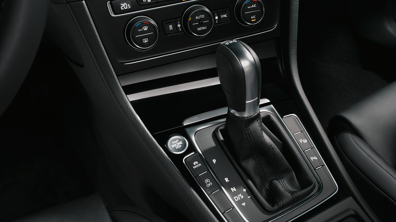 Volkswagen automatic transmission safety features A view of a Volkswagen vehicle's interior central console system and features.